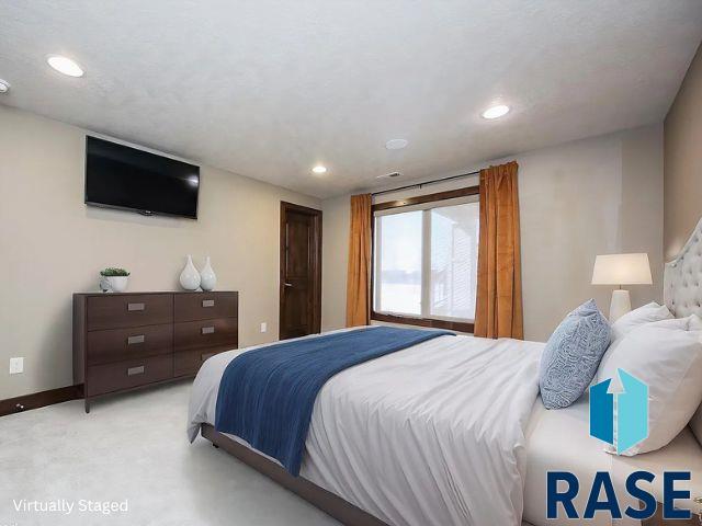 bedroom with recessed lighting, baseboards, and light carpet