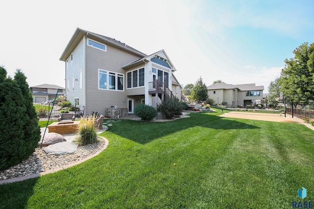 rear view of house featuring a yard, fence, and a patio area