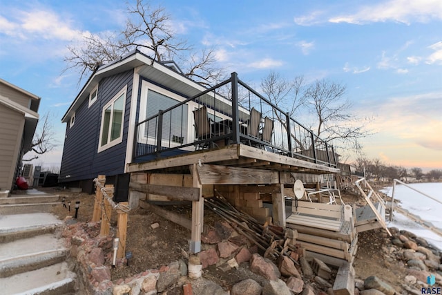 view of home's exterior featuring a wooden deck and stairs