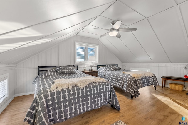 bedroom featuring a ceiling fan, lofted ceiling, and wood finished floors