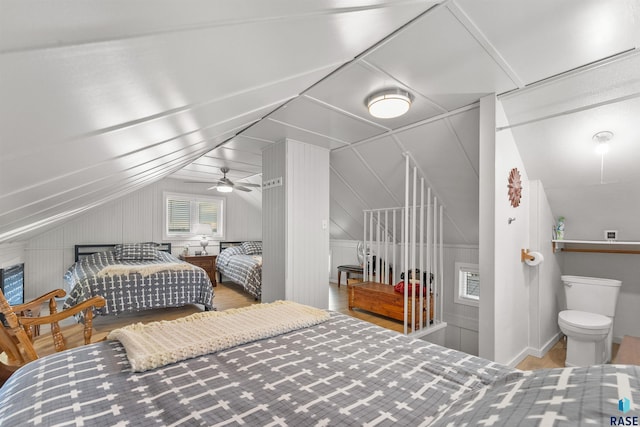 bedroom with wood finished floors and vaulted ceiling