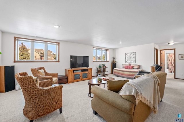 living room with recessed lighting and light carpet