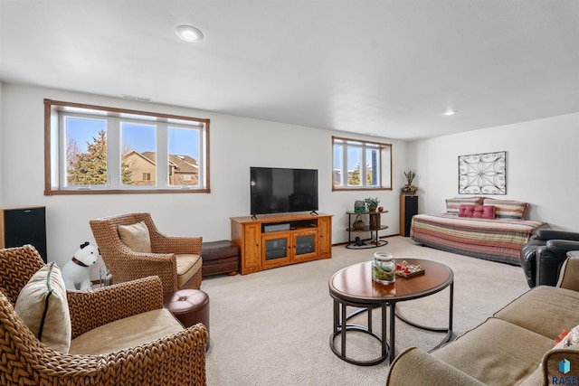 living room featuring recessed lighting, visible vents, and light colored carpet