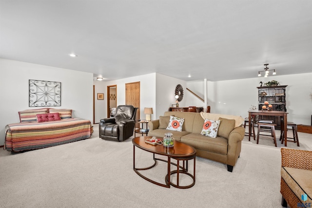 living area featuring stairs, recessed lighting, and light carpet