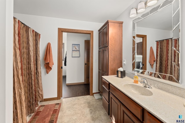 bathroom with baseboards and vanity