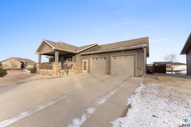 single story home featuring stone siding, concrete driveway, a garage, and a shingled roof