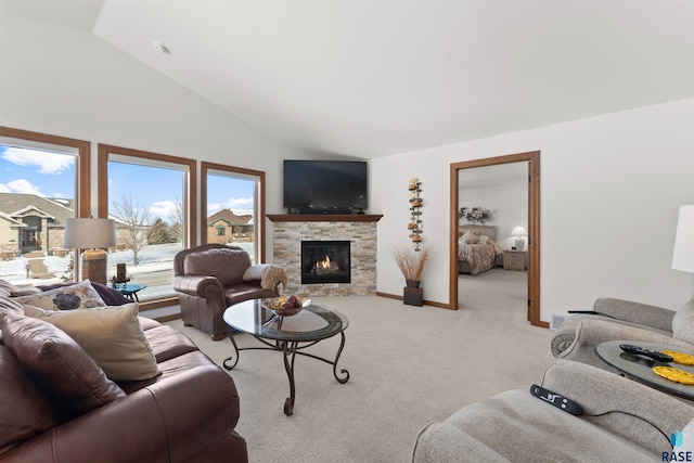 living room with light carpet, a stone fireplace, baseboards, and lofted ceiling