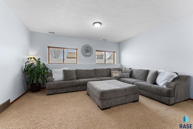 living area featuring visible vents, baseboards, and carpet