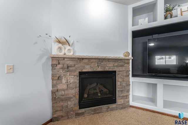 room details with built in features, a stone fireplace, and carpet floors