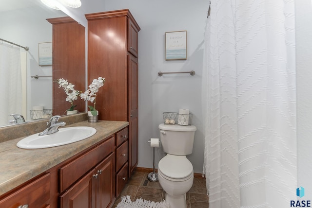 bathroom featuring vanity, baseboards, tile patterned flooring, curtained shower, and toilet