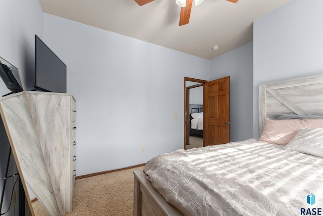 carpeted bedroom featuring baseboards and a ceiling fan