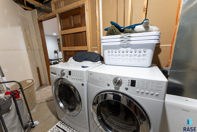 laundry area with washing machine and clothes dryer and laundry area