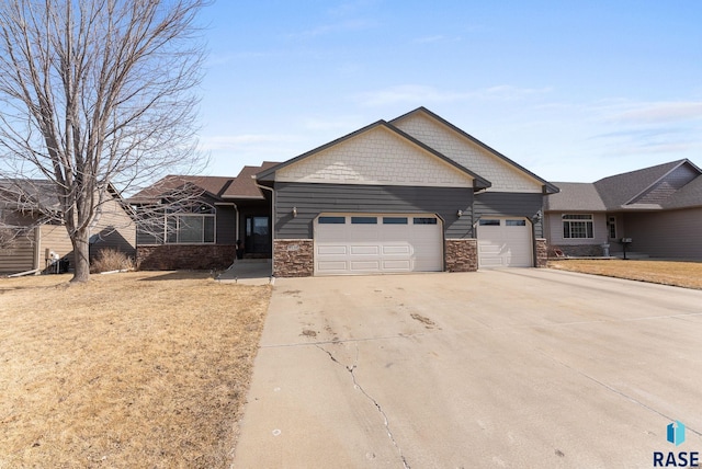 craftsman house with a front lawn, stone siding, a garage, and driveway