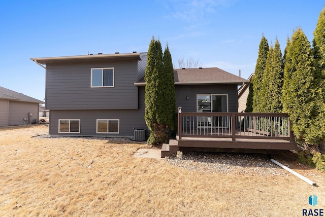 back of property with cooling unit and a deck