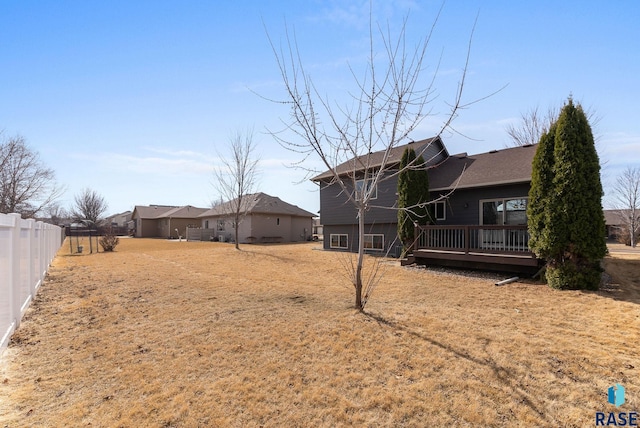 view of yard featuring a deck and fence