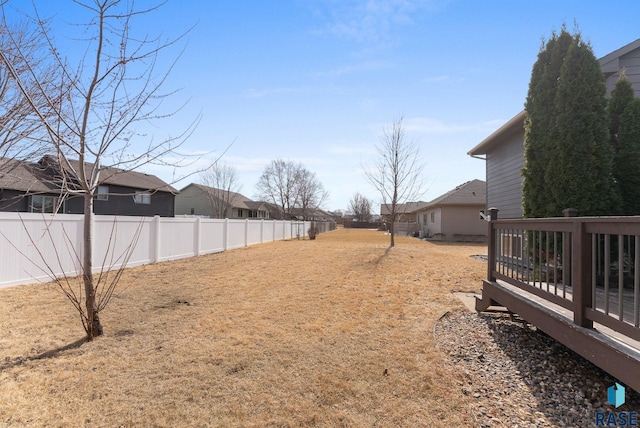 view of yard featuring a deck and fence