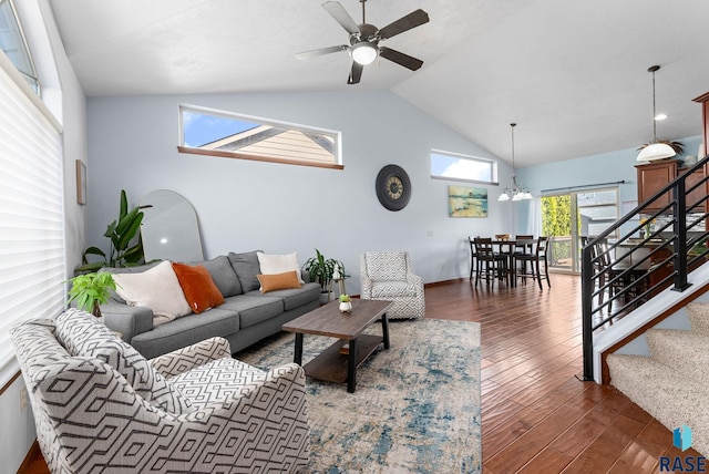 living area featuring stairway, ceiling fan with notable chandelier, high vaulted ceiling, and wood finished floors