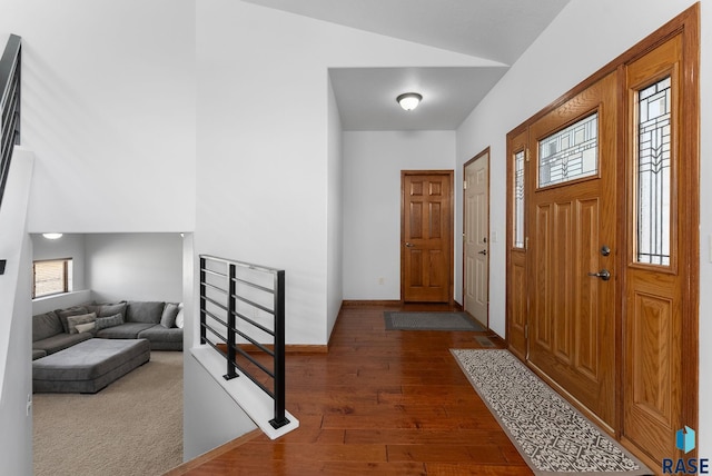 foyer with baseboards and hardwood / wood-style flooring