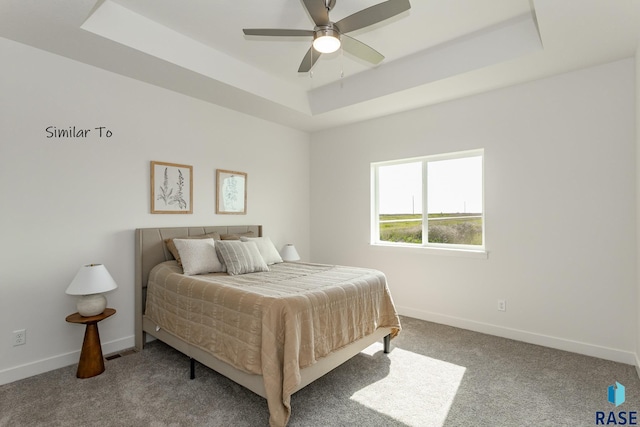 bedroom featuring carpet flooring, a ceiling fan, a raised ceiling, and baseboards