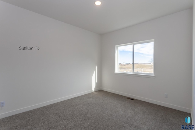 spare room featuring recessed lighting, carpet flooring, baseboards, and visible vents