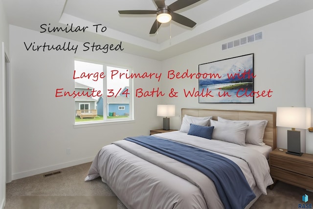 bedroom with visible vents, baseboards, carpet, and a tray ceiling