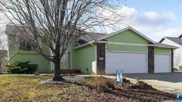 view of property exterior featuring stone siding, a garage, and driveway