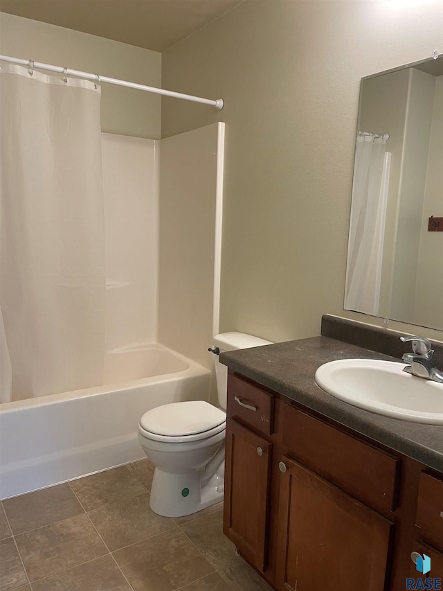 full bathroom featuring tile patterned flooring, toilet, vanity, and shower / bath combination with curtain