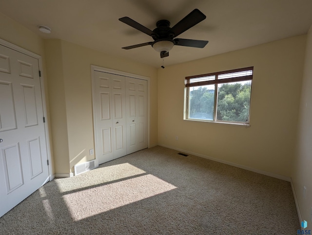 unfurnished bedroom featuring a closet, baseboards, carpet, and visible vents