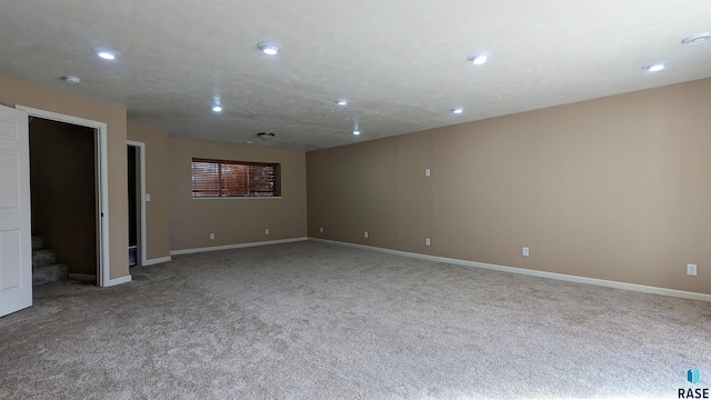 carpeted spare room with recessed lighting and baseboards