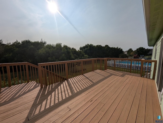 wooden deck with an outdoor pool