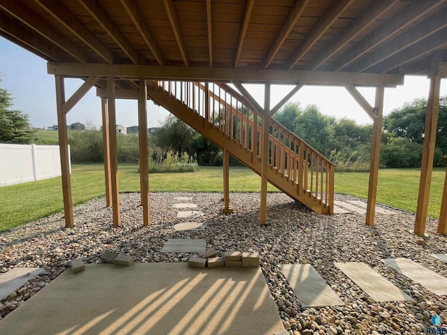 view of patio / terrace with stairway and fence