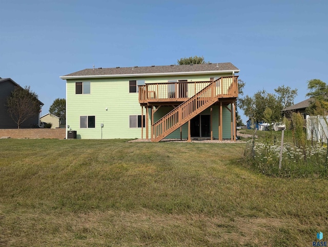 back of house featuring a wooden deck, stairs, and a yard