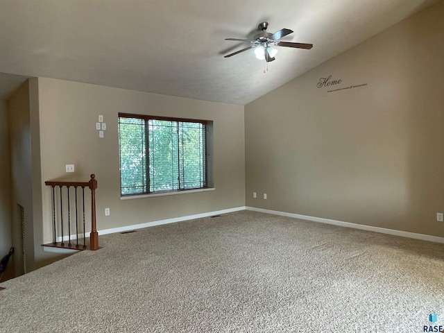 spare room with visible vents, lofted ceiling, a ceiling fan, carpet floors, and baseboards