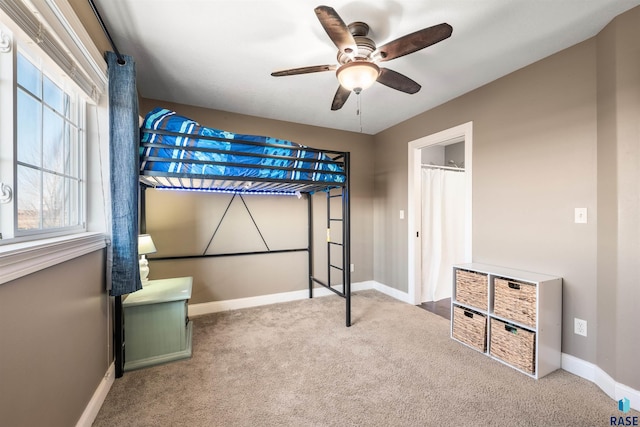 bedroom with carpet, baseboards, and ceiling fan