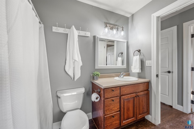 full bath with vanity, toilet, wood finished floors, and baseboards