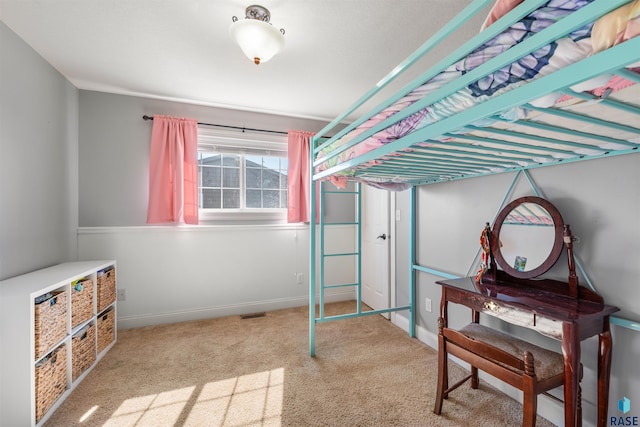 carpeted bedroom featuring baseboards