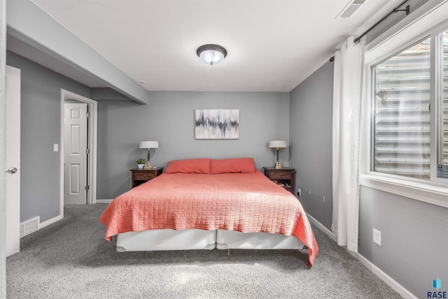 carpeted bedroom with baseboards and visible vents