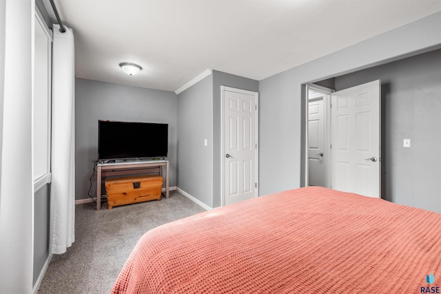 carpeted bedroom featuring baseboards