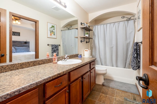 full bath with vanity, shower / bath combination with curtain, toilet, and visible vents