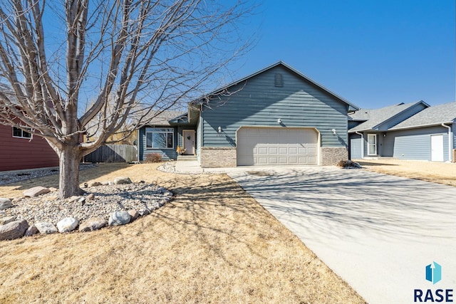 ranch-style house with brick siding, concrete driveway, a garage, and fence