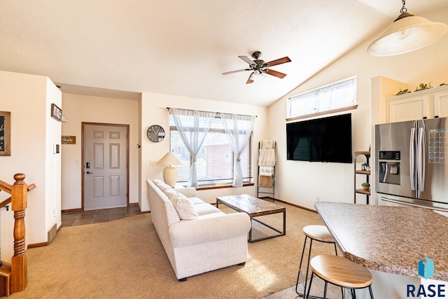 living area with a ceiling fan, visible vents, baseboards, vaulted ceiling, and light carpet