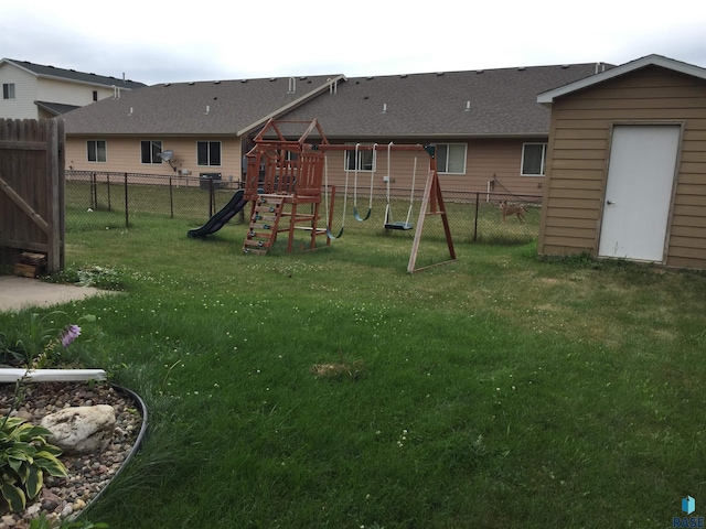 exterior space with a playground and a fenced backyard