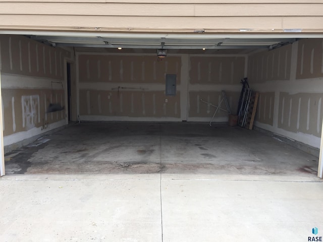 garage with electric panel and a garage door opener