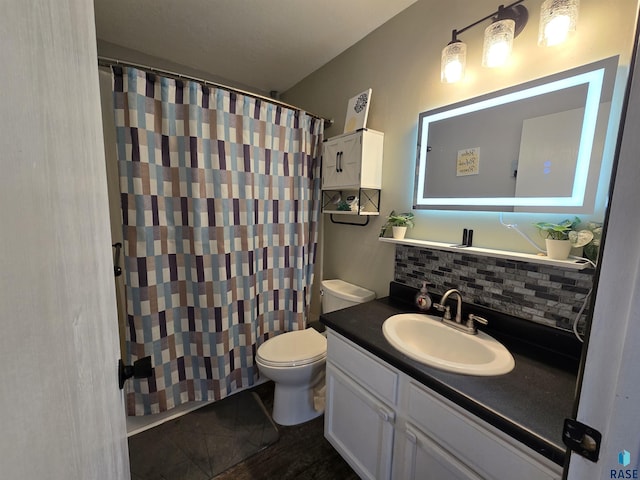 bathroom with vanity, a shower with shower curtain, toilet, and backsplash