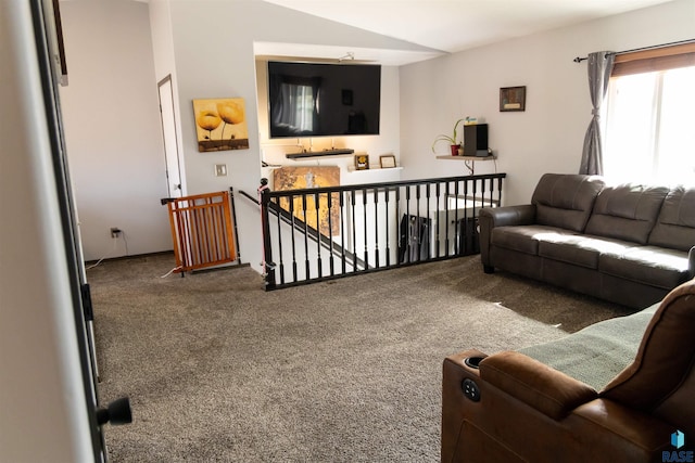 carpeted living room with lofted ceiling