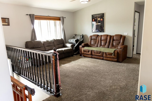 carpeted living area featuring lofted ceiling