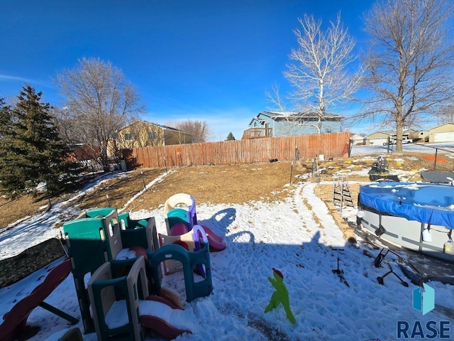 yard layered in snow with fence