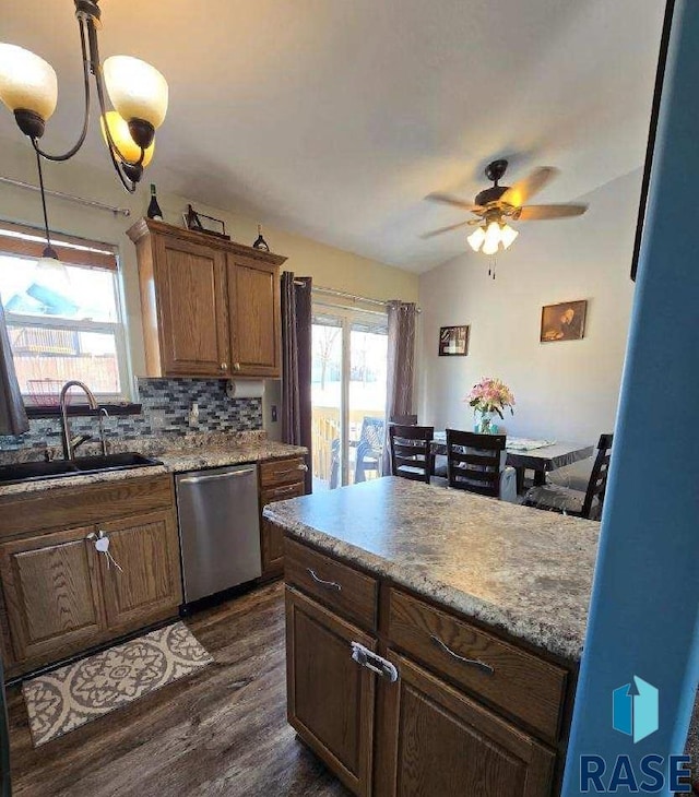 kitchen with a sink, stainless steel dishwasher, dark wood finished floors, decorative backsplash, and ceiling fan