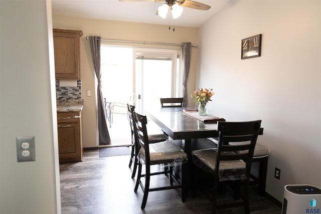 dining space with a ceiling fan and wood finished floors