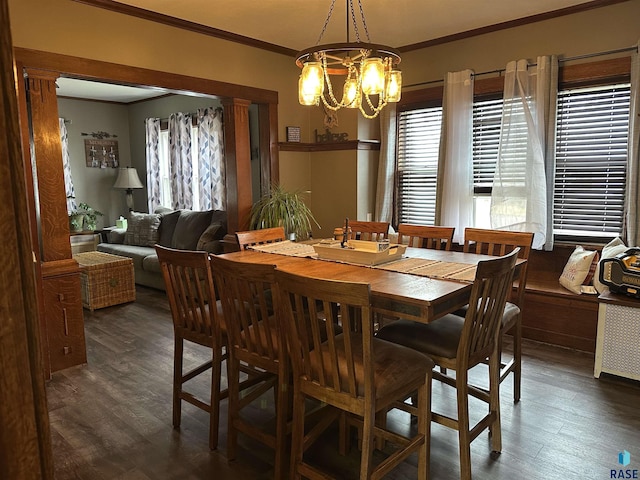 dining space with a chandelier, wood finished floors, and crown molding